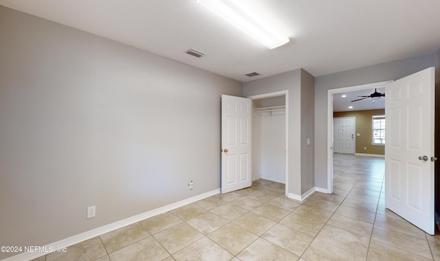 unfurnished bedroom with a closet and light tile patterned floors