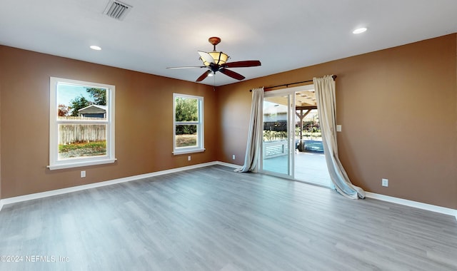 spare room featuring ceiling fan and hardwood / wood-style floors