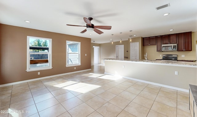 kitchen with ceiling fan, sink, light stone counters, black electric range oven, and light tile patterned flooring