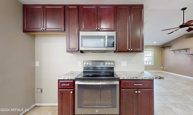 kitchen featuring light stone countertops, stainless steel appliances, ceiling fan, lofted ceiling, and light tile patterned flooring