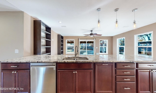 kitchen with pendant lighting, sink, ceiling fan, light stone countertops, and kitchen peninsula