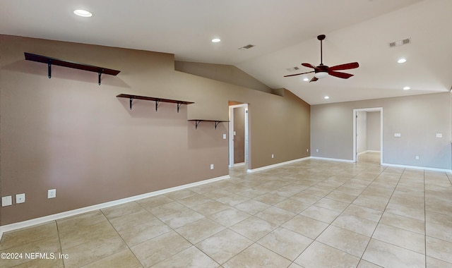 tiled empty room with vaulted ceiling and ceiling fan