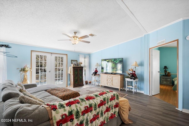 living room featuring a textured ceiling, ceiling fan, dark hardwood / wood-style flooring, and french doors