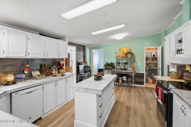 kitchen featuring dishwasher, light wood-type flooring, white cabinets, and stainless steel electric range