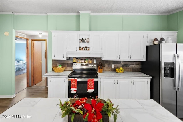 kitchen with white cabinets, appliances with stainless steel finishes, and light hardwood / wood-style floors