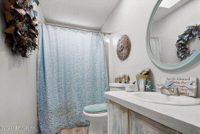 bathroom with vanity, a shower with shower curtain, toilet, a textured ceiling, and wood-type flooring