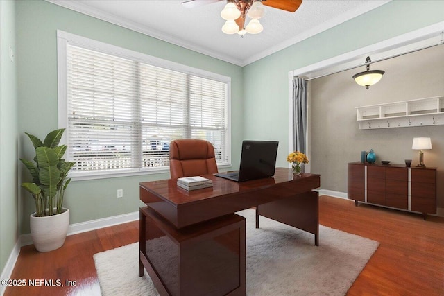 home office with hardwood / wood-style floors, a wealth of natural light, ornamental molding, and ceiling fan