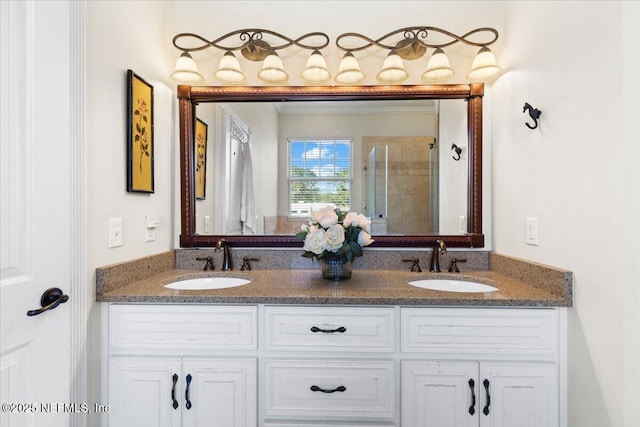 bathroom with vanity and a shower with door