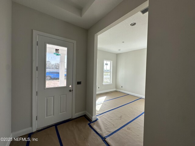 foyer featuring baseboards