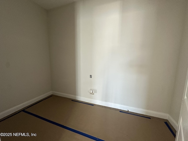 unfurnished room with baseboards