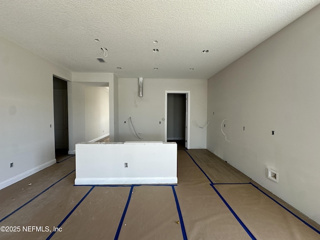 empty room featuring a textured ceiling and visible vents