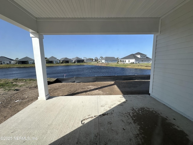 view of patio / terrace featuring a water view and a residential view