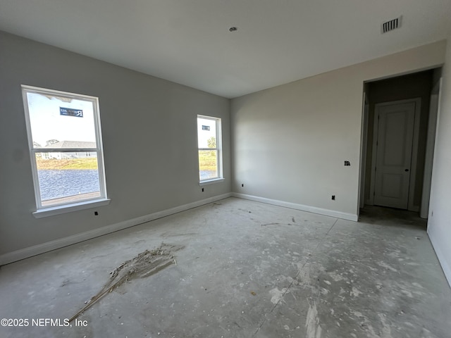 unfurnished room with visible vents and baseboards