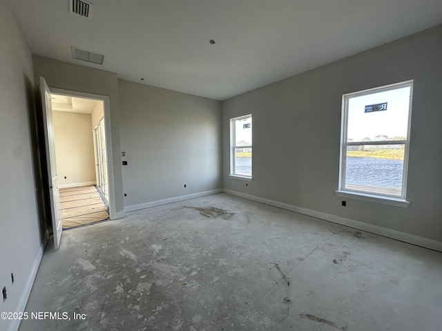 unfurnished room featuring visible vents and baseboards