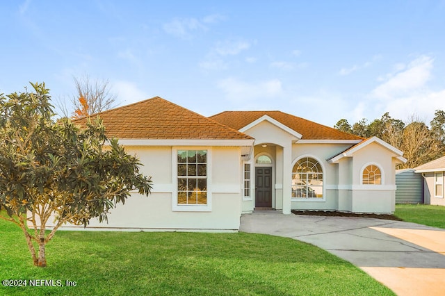 mediterranean / spanish house with a front yard