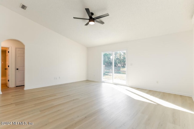 empty room featuring ceiling fan, light hardwood / wood-style floors, and lofted ceiling