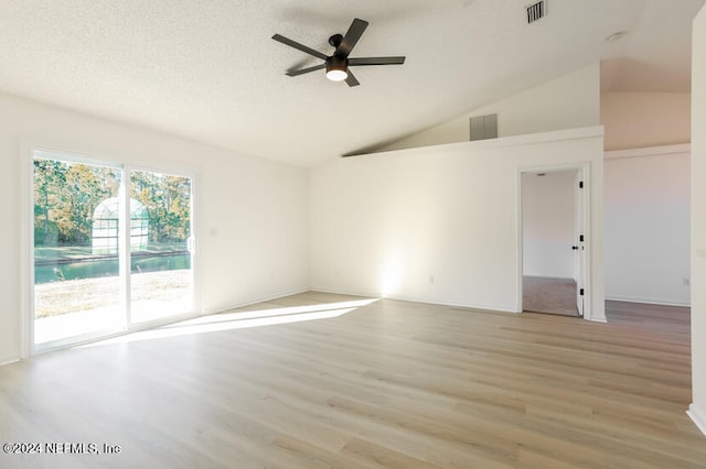 empty room with ceiling fan, light wood-type flooring, a textured ceiling, and high vaulted ceiling