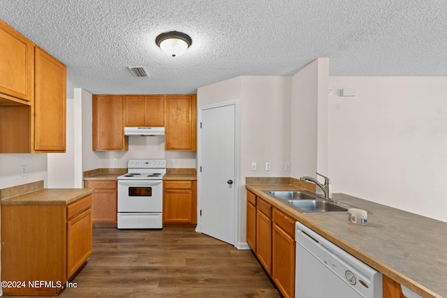 kitchen with a textured ceiling, dark hardwood / wood-style floors, white appliances, and sink