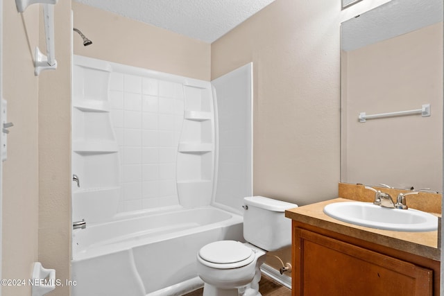 full bathroom featuring bathing tub / shower combination, vanity, a textured ceiling, and toilet