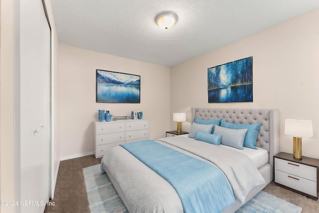 bedroom with light colored carpet and a closet