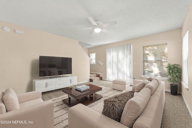 living room featuring ceiling fan and light colored carpet