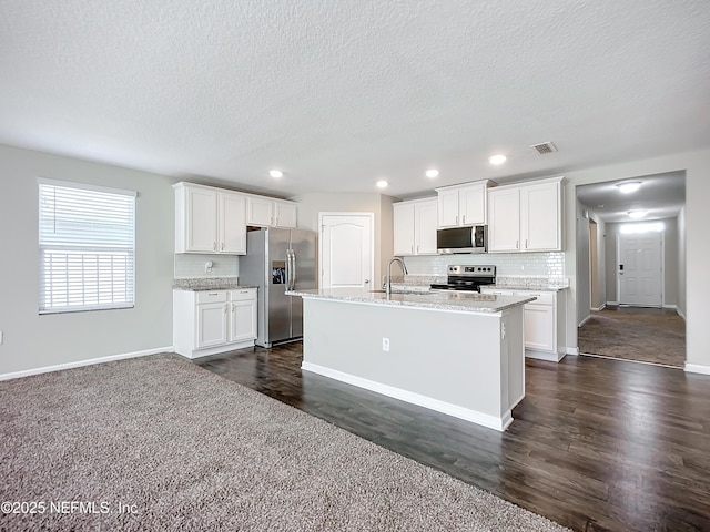 kitchen featuring white cabinets, appliances with stainless steel finishes, backsplash, and sink