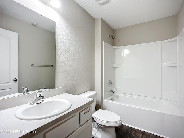 full bathroom featuring toilet, wood-type flooring, shower / tub combination, and vanity