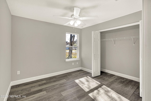 unfurnished bedroom with ceiling fan, dark hardwood / wood-style floors, and a closet