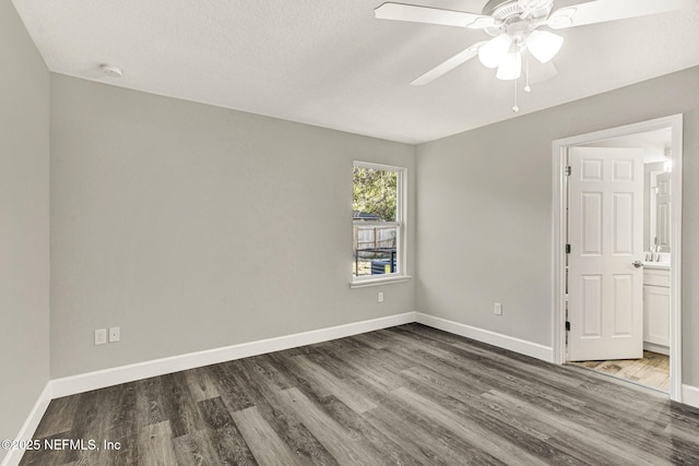 unfurnished room with ceiling fan and dark hardwood / wood-style flooring