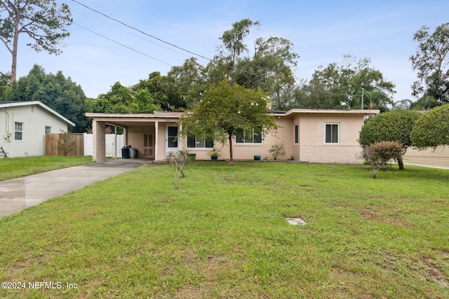 ranch-style house featuring a front yard and a carport