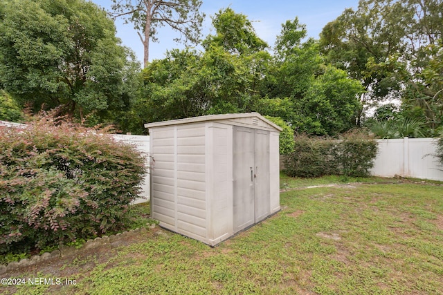 view of outbuilding with a lawn