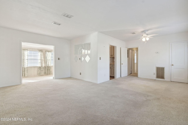 carpeted empty room featuring ceiling fan