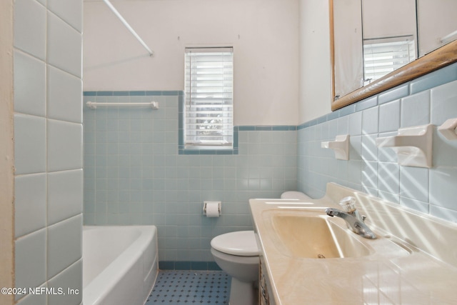 bathroom with vanity, a bath, tile walls, and toilet