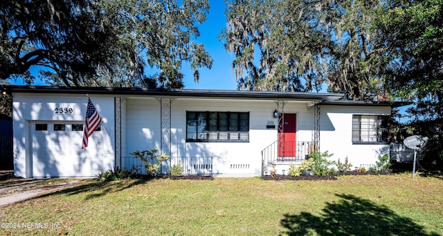 view of front facade with a garage and a front lawn