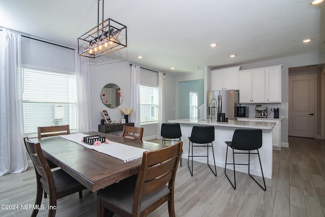 dining area featuring light hardwood / wood-style floors and sink