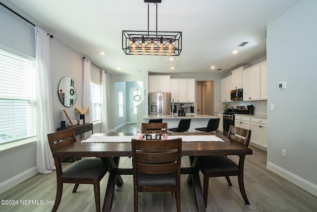 dining space with hardwood / wood-style flooring and a healthy amount of sunlight