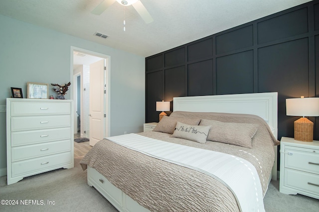 bedroom with light carpet and ceiling fan