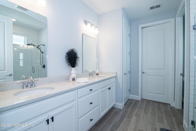 bathroom featuring vanity and an enclosed shower