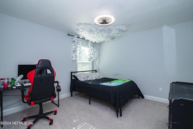 bedroom featuring light colored carpet and a textured ceiling