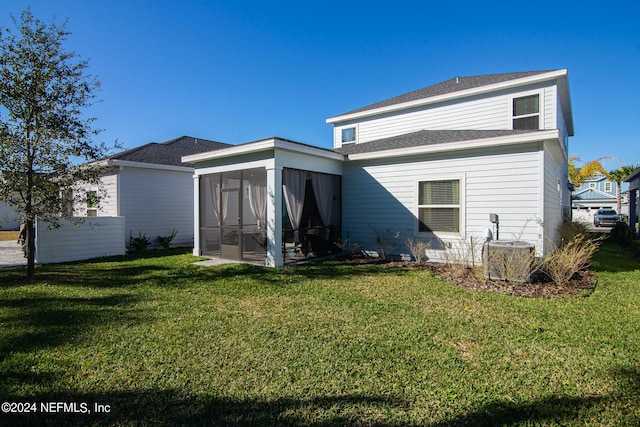 back of property featuring a sunroom, cooling unit, and a lawn