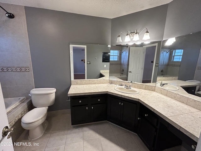 bathroom with a tile shower, tile patterned flooring, a textured ceiling, toilet, and vanity