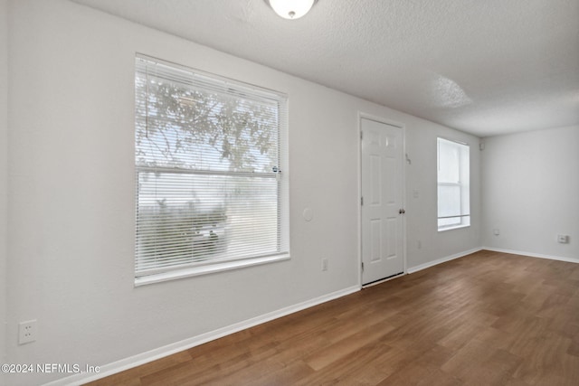 foyer featuring hardwood / wood-style flooring and a textured ceiling