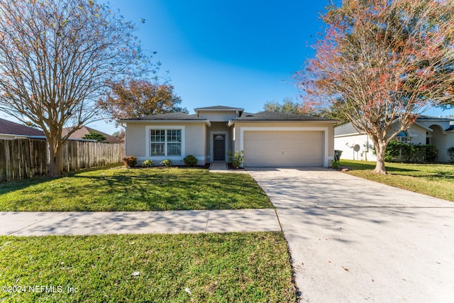 view of front of home featuring a front yard and a garage