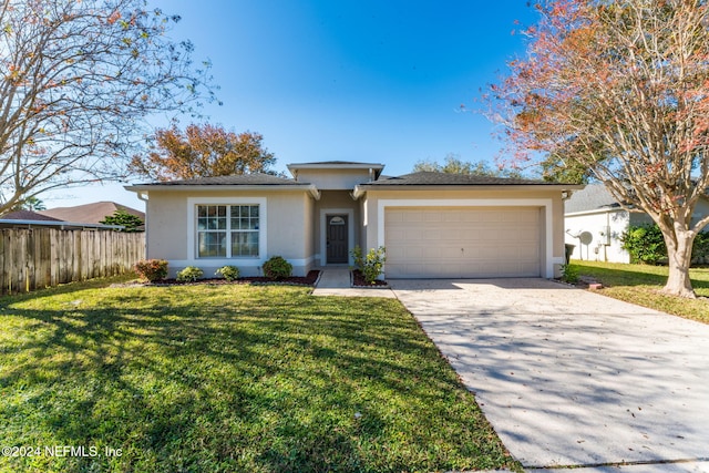 view of front of property with a front yard and a garage