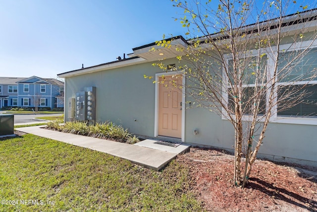 entrance to property with a yard