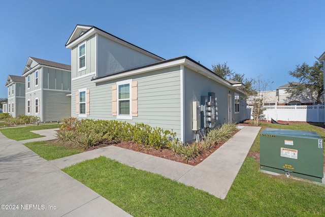 view of side of home featuring a yard