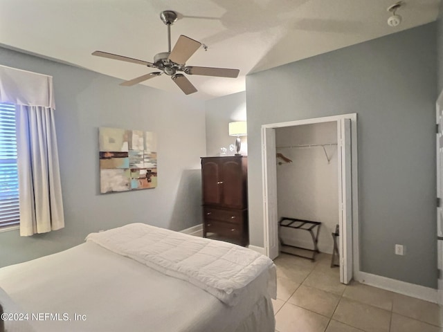 bedroom with a closet, ceiling fan, and light tile patterned flooring