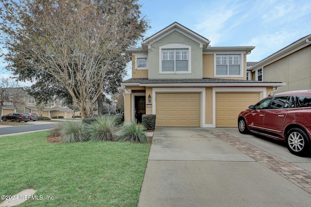 front of property with a front yard and a garage