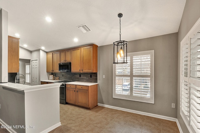 kitchen featuring pendant lighting, backsplash, black range oven, kitchen peninsula, and a chandelier