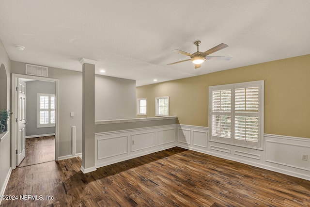 empty room with ceiling fan and dark wood-type flooring